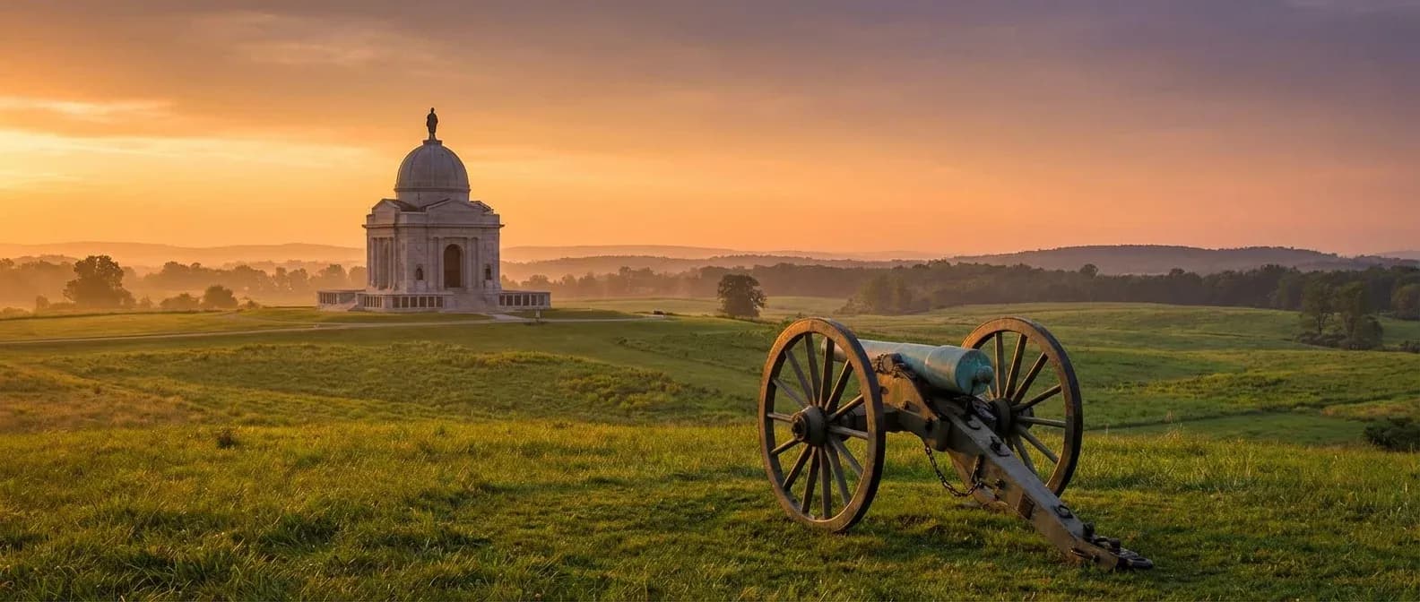 Gettysburg battlefield with historic Civil War cannon at sunset