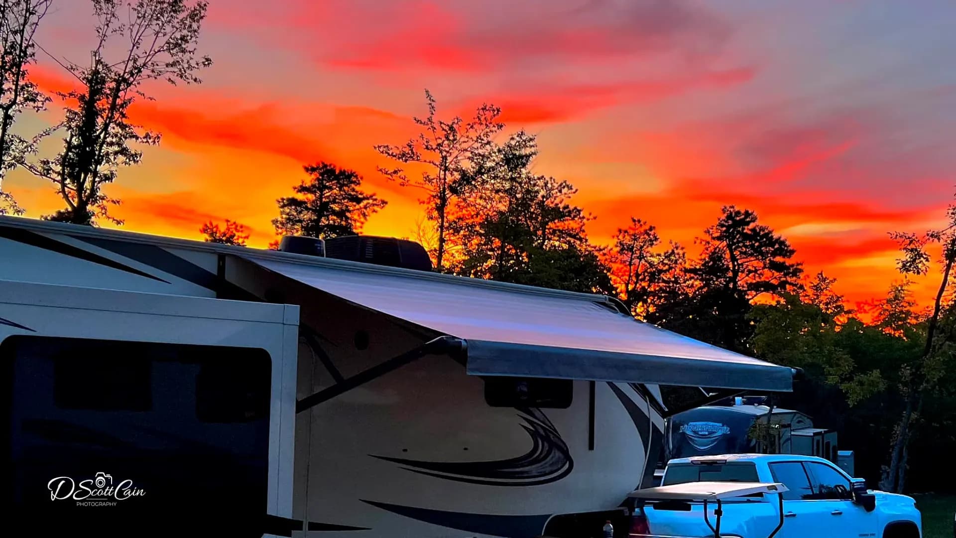 RV silhouette against fiery sunset