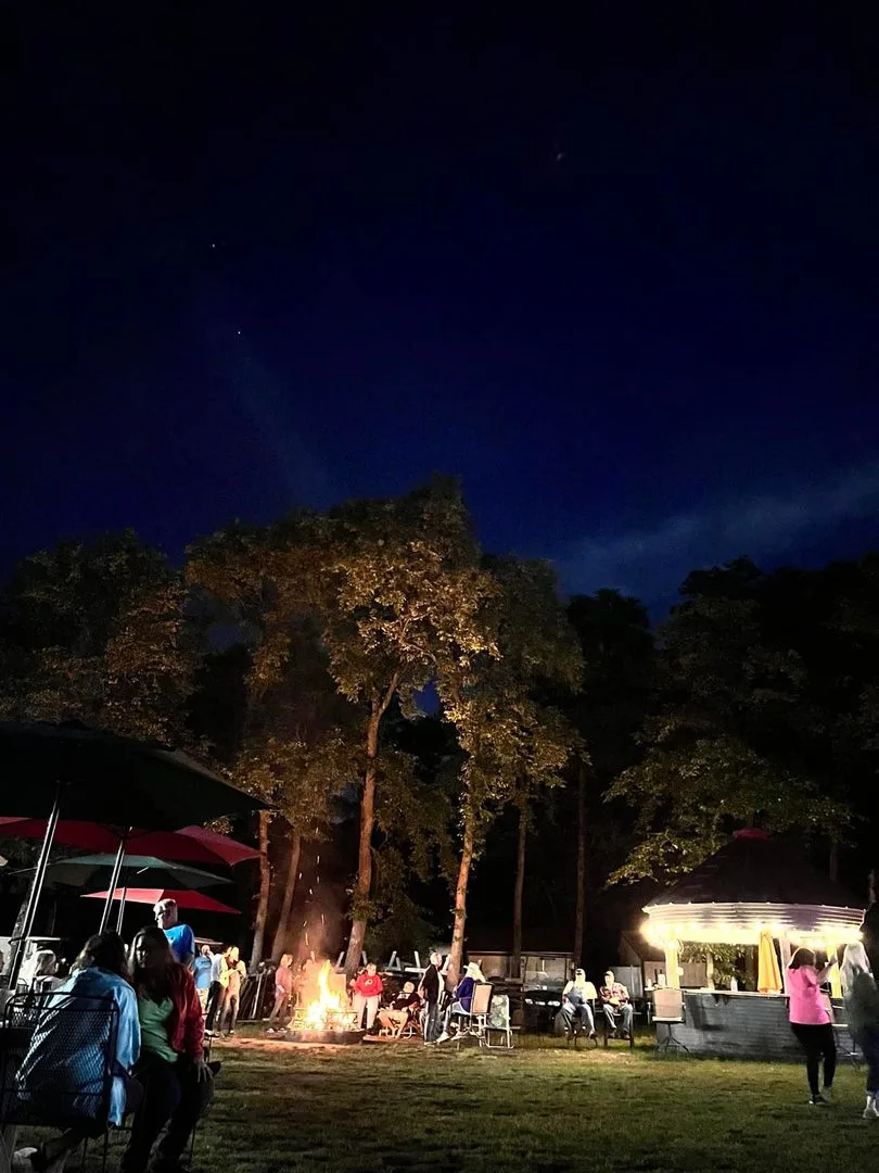 Pine Ridge campers gathering around a campfire